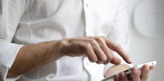 person holding white Android smartphone in white shirt