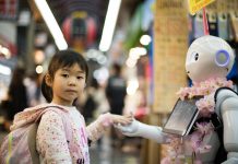 photo of girl laying left hand on white digital robot
