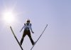 a man flying through the air while riding skis