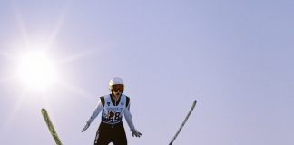 a man flying through the air while riding skis