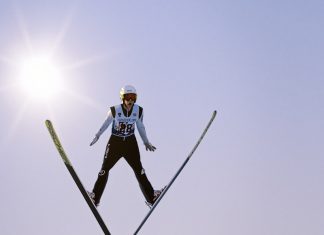 a man flying through the air while riding skis