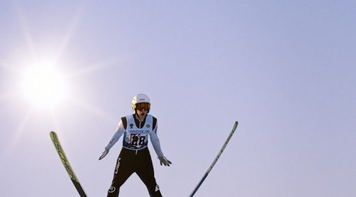 a man flying through the air while riding skis