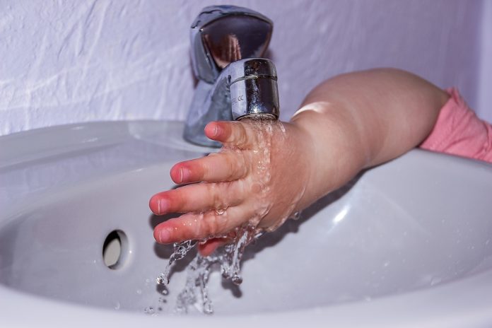 tap water running and toddler washed his hand